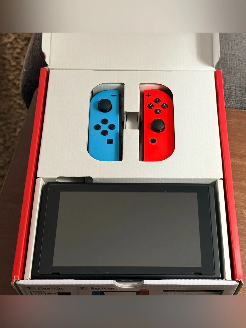Nintendo Switch with Neon Blue and Neon Red Joy-Con Controllers